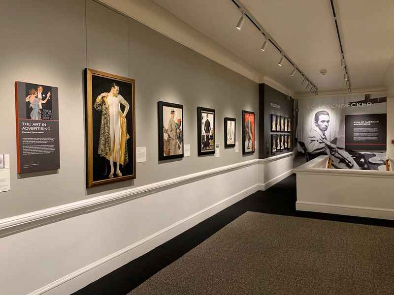 a room with several framed pictures on the wall