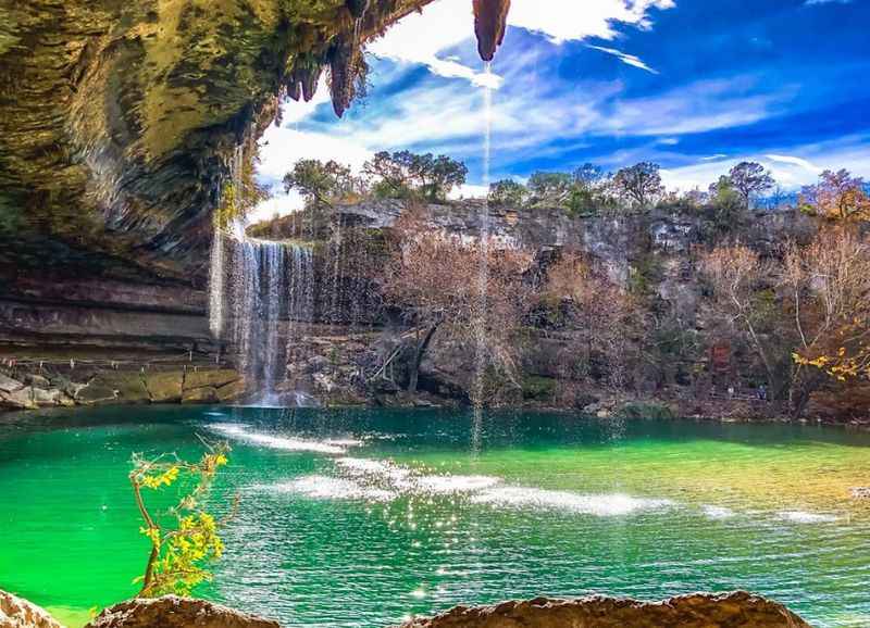 a large waterfall in the middle of a lake