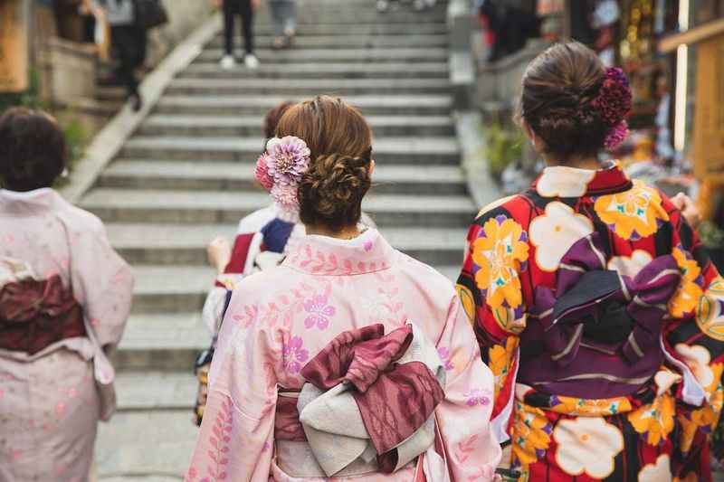 Anonymous women in traditional apparel in city