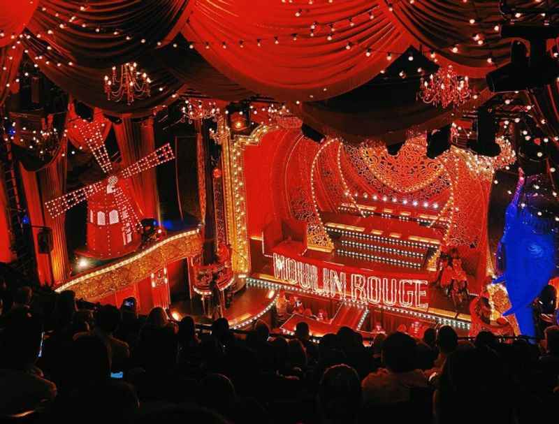 a stage with a red curtain and a stage set