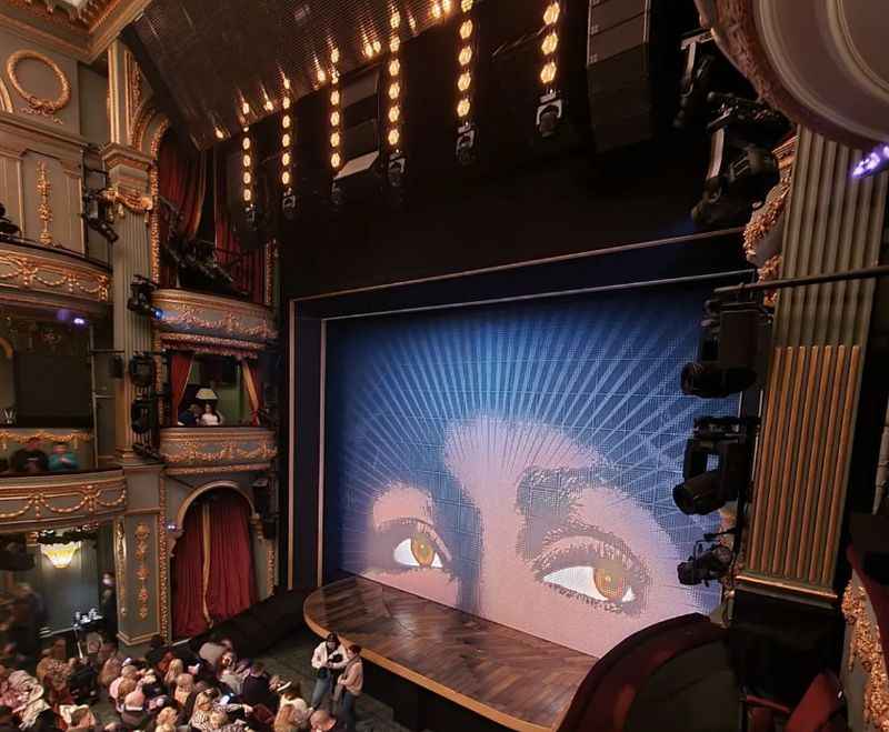 a large screen of a woman's eye on the stage