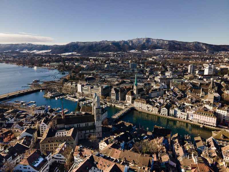 aerial view of city buildings near body of water during daytime