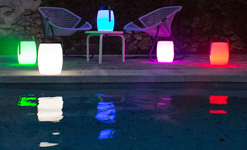 Lampes colorées posées au bord d'une piscine