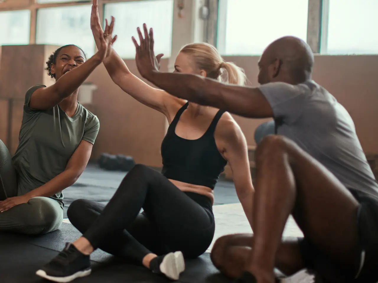 Group of friends high-fiving after a workout