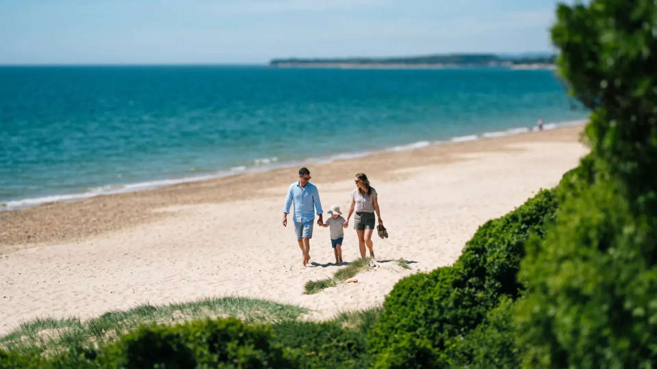 A family walking on the beach near Christchurch