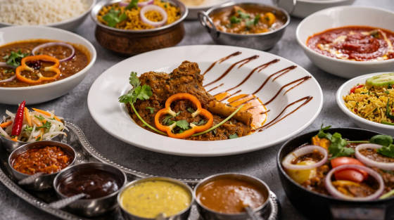 An array of Indian dishes including curries, rice, and condiments