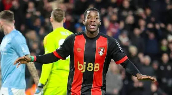 Bournemouth player in black and red kit reacting on the pitch