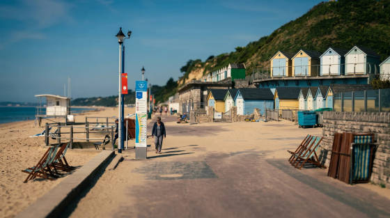 Colourful beach huts and a sandy promenade in Bournemouth