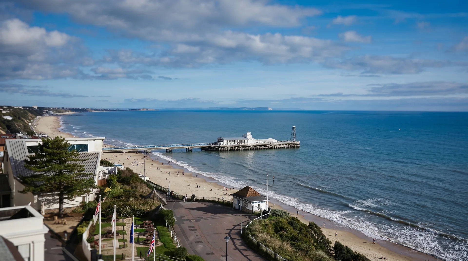 View of Bournemouth beach and pier under a blue sky with scattered clouds