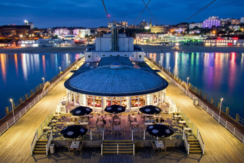 Bournemouth Pier lit up at dusk