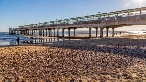 Bournemouth Pier with sandy beach and sea in the background