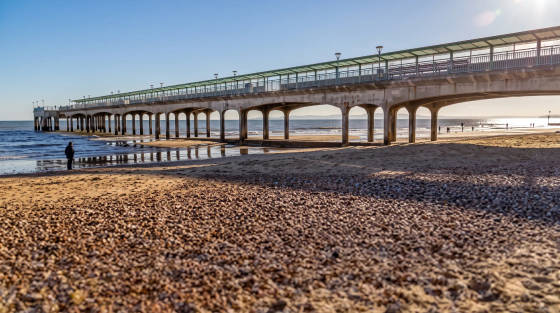 Bournemouth Pier with sandy beach and sea in the background