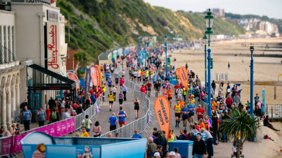 Crowd of runners and spectators along Bournemouth seafront