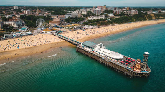 Aerial view of Bournemouth Pier, beach, and Ferris wheel