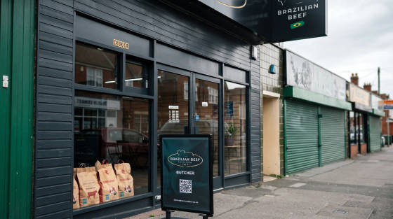 Exterior of Brazilian Beef butcher shop with bags visible