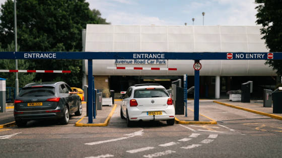 Entrance sign and vehicles at Avenue Road Car Park