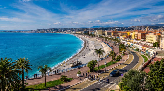 Aerial view of a beach with turquoise water and promenade