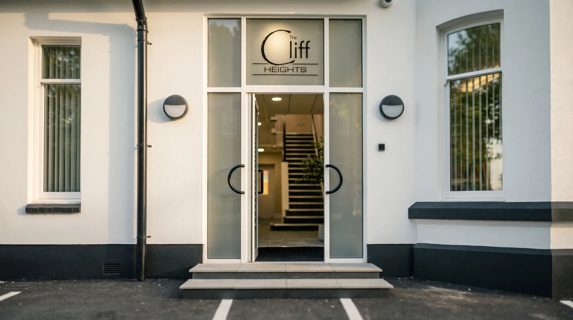 Entrance to Cliff Heights Apartments with glass doors and modern signage