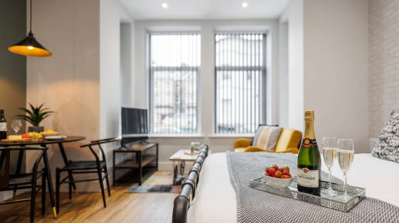 Modern apartment living area with champagne and strawberries