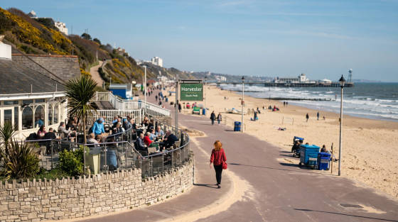 Outdoor dining area of Harvester restaurant with people enjoying the sun