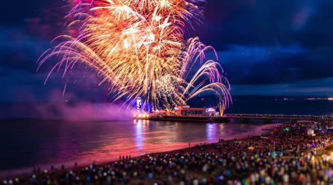 Bright fireworks illuminate the night sky above Bournemouth Pier