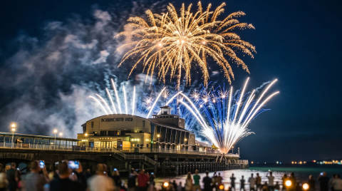 Fireworks bursting in the night sky above Bournemouth Pier