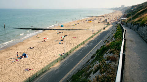 Bournemouth beach with sunbathers and a promenade