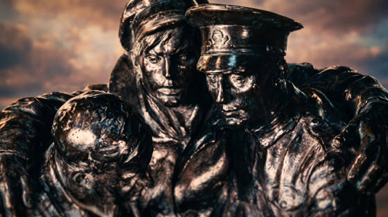 Close-up of a bronze sculpture depicting three soldiers