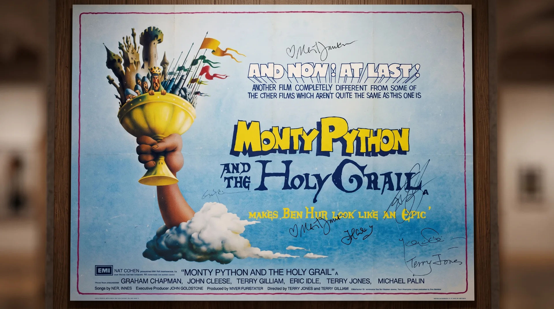 A vintage poster for Monty Python and the Holy Grail featuring a golden chalice and signatures from cast members.