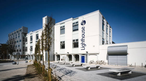 Modern Lighthouse building with blue door and benches