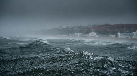 Choppy sea with dark clouds and distant coastline in Bournemouth