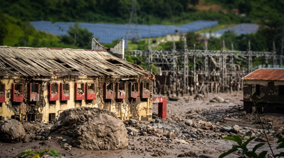 Ruined building with broken windows and power lines in the background