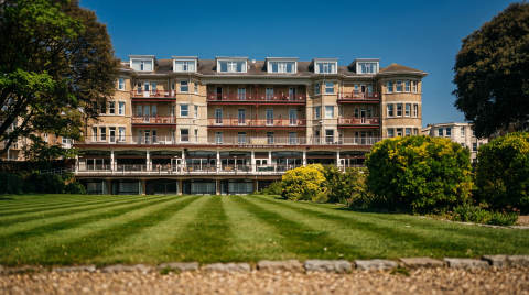 The Grand Albion Hotel with manicured gardens in front
