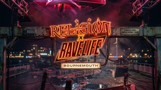 Neon sign for Religion x Rave Life at night on Bournemouth Pier