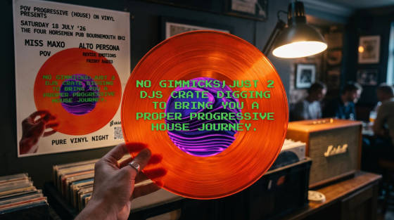 An orange vinyl record held in front of a poster and a speaker