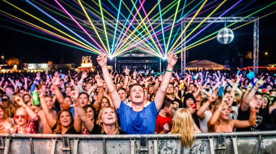 Festival crowd with laser lights and a disco ball