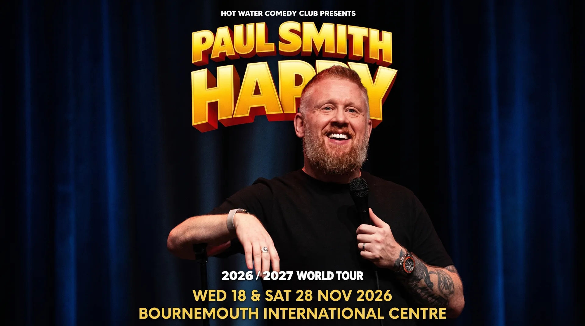 A comedian with a beard smiles while holding a microphone, with a blue curtain backdrop and event details below.