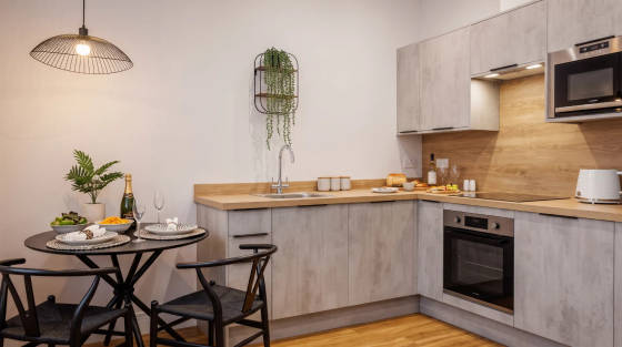 Stylish kitchen with a dining table, plants, and modern appliances