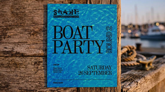 Bright blue flyer for a boat party on a wooden surface