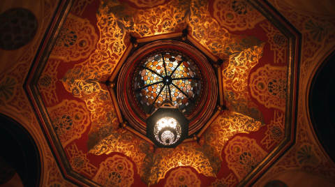 Intricate ceiling design with a stained glass lantern