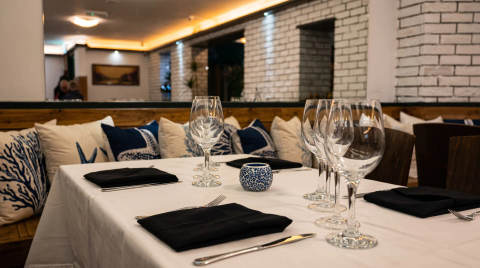 Table set with glasses and cutlery in a restaurant interior