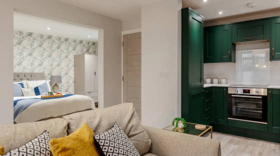 Interior of a modern apartment showing kitchen and bedroom