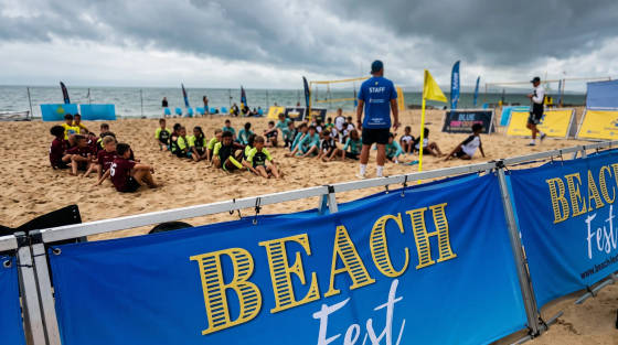 Children sitting on the sand during a beach event in Bournemouth
