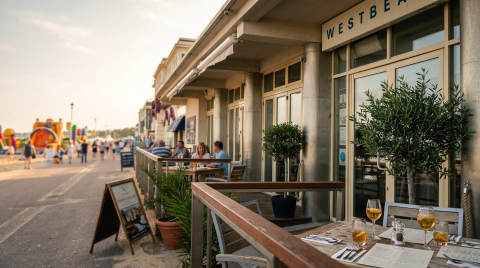 Tables set for dining outside Westbeach restaurant with beach in background