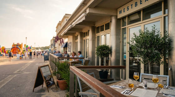 Tables set for dining outside Westbeach restaurant with beach in background