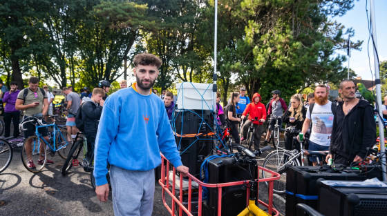 Group of people with bicycles and equipment in a park