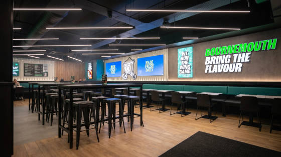 Modern restaurant interior with seating and neon signage