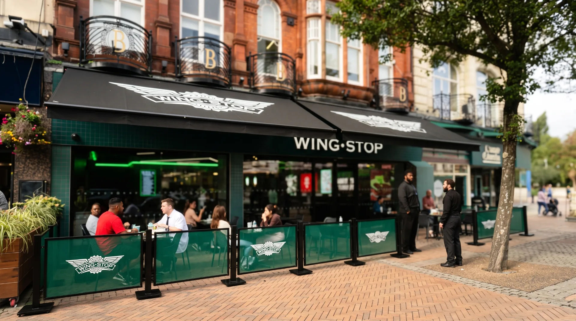 Wingstop restaurant exterior with outdoor seating and staff in Bournemouth's The Square
