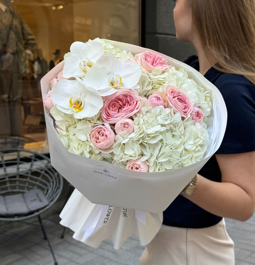 A bouquet of hydrangeas, soft pink roses, and white orchids.
