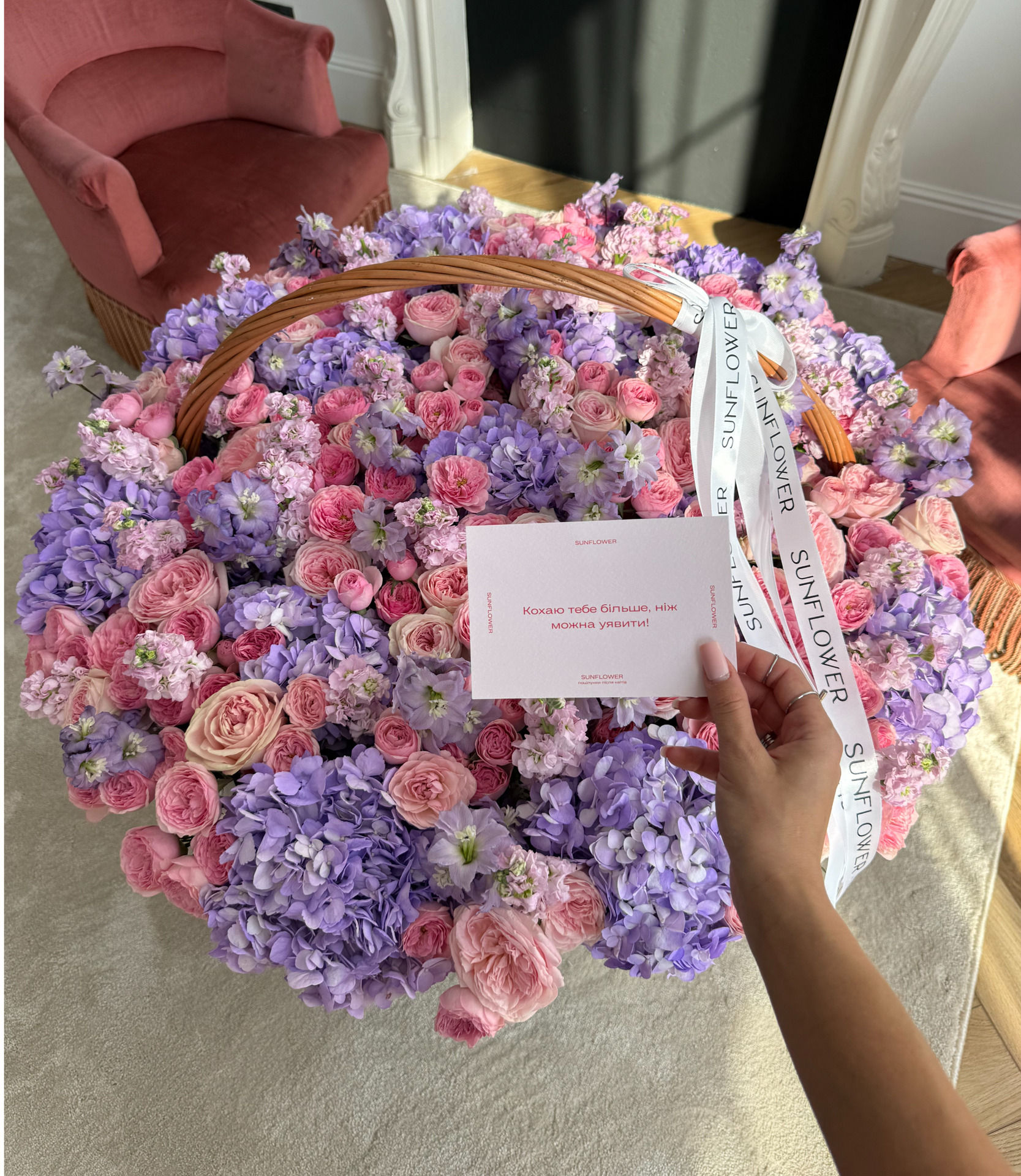 Arrangement in a basket of lavender hydrangeas, shrub roses and delicate mattiola